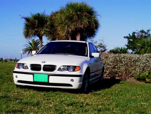 White Car with Green License Plate - A white BMW with the Green License Plate campaign. goto http://www.earthrehab.com and join the mission to save the planet.