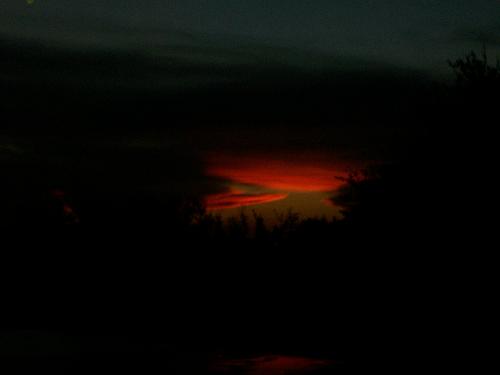 Sunset - This is a picture of the sunset on a bleak dark cloudy day.