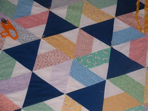 close up of "Triangle Tribulation" - This is a quilt I made from my MIL. It&#039;s pattern was from a Fons and Porter magazine, their quilt was titled "Wedding Wishes."