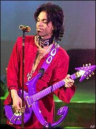 Prince  - Prince dressed in red playing purple 0-+guitar