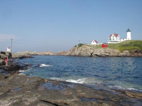 Lighthouse - This is a picture that I took in one of my many vacations to Maine. If I remember right this is the Nubble Lighthouse. This is located in the very south part of Maine. It is very relaxing, just sitting there and watching the waves.