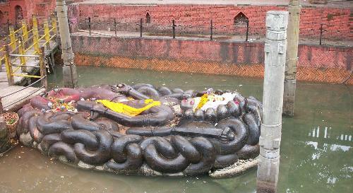 The Sleeping Vishnu - The monolithic statue of the giant Budhaneelkant - sleeping Vishnu in Nepal. The 2/3rd of the idol is submerged in water and it is 18 feet in length.
