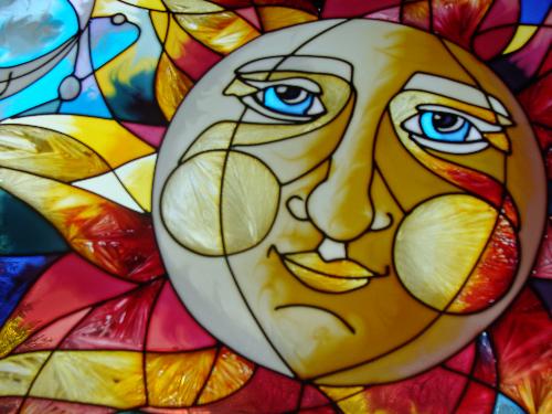 Sun symbol in stained glass - Close up of sun symbol hanging in my office