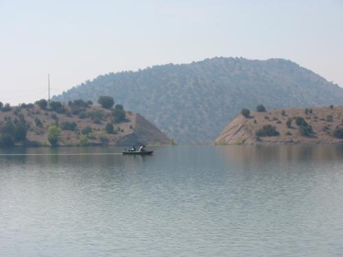 Picturesque scene of two fisherman - A couple of fisherman on a Bill Evans lake in New Mexico.