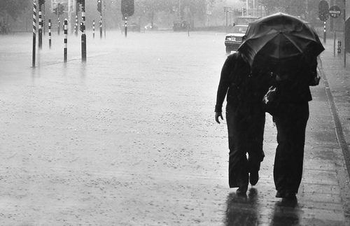 walking in the rain - shows a couple walking under the rain