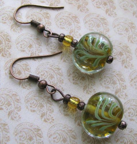 Bamboo Bead Earrings - This pair of antique copper earrings hang approx. 1' from fish hook style earwires. The focal bead is glass with a swirl of green and amber. The bead resembles bamboo, thus the name! Available at my shop on Etsy.com