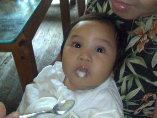 feeding frenzy - my mom feeding my dear nephew. his first taste of food aside from milk