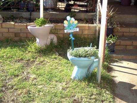 Welcome to my home. - Herb containers and welcome sign near the steps to my front door.