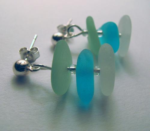Sea Breeze Sea Glass Earrings - Three delicate pieces of sea glass in seafoam green, aqua blue, and a frosty clear, hang on a sterling silver post style earring.
This sea glass is smooth and beautifully frosted by nature&#039;s elements.
All pieces of sea glass used in this creation were found on the beaches of Hawaii.