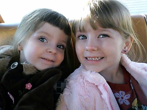 My Girls - This is my oldest daughter Ally and my youngest daughter Brenna sitting together in the back seat of our car. They were helping clean out the inside of the car on this day. It was one of very few warmer days that we had this winter and we took the opportunity to go outside and play and clean up. They love the outdoors very much and as if you can't tell, they love each other very much as well.