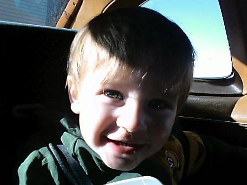 My son - This is my youngest child and my only son. He is a year and a half old and quite ornery. He loves to take car rides. We had to go to town and he kept laughing and smiling while he was looking out the window so I couldn't help but take a picture of his adorable grin. He's such a sweet boy. If you hold your fist out to him and tell him to give you knuckle love he'll come up to you and bump his fist against yours. He loves to give out kisses and hugs and some of his favorite movies are The Neverending Story, Nemo, Shrek 3 and Over the Hedge.