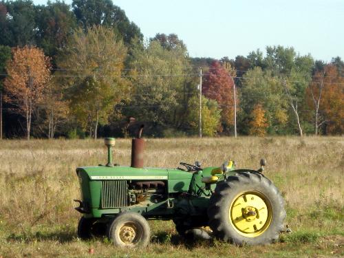 John Deere Tractor in the fall - I seen this not too far from my house I was really like the look of the fall colors that was in the background.
