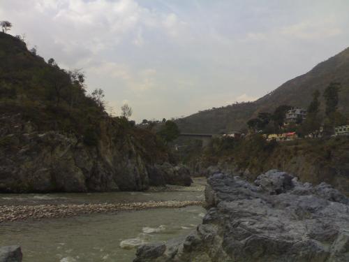 people bathing in hot spring - this photograph was taken from a hot water spring near a river where people take bath believing that it will cure there ailments
