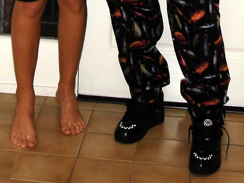 Do you wear shoes at home? - A picture of 2 pairs of legs. One with shoes and one without - barefooted. Photo source: http://farm1.static.flickr.com/28/49588015_557381f191.jpg?v=0 .