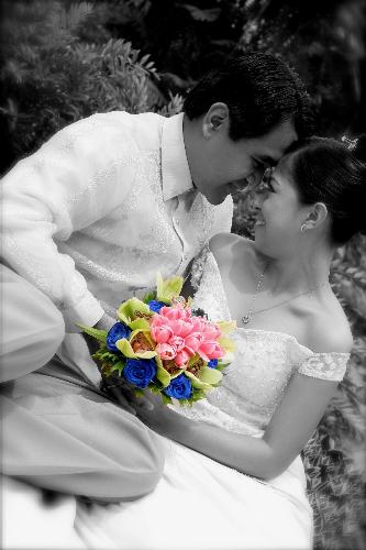 Newylweds - This was a photo taken at our reception venue during our wedding last October 2007. It was almost noon at the time the photo was taken so you can just imagine how hot it is and we are exposed under the sun.