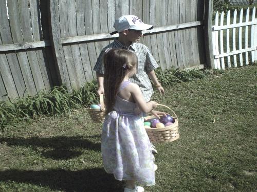 2 of my grandchildren hunting eggs - Bradley is helping Brittney find eggs.