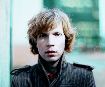 Beck - Beck with Green street background wearing a jacket