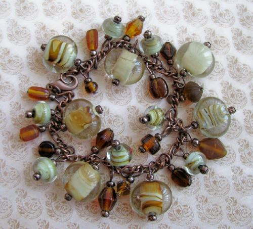 River Rock Bracelet - A 7 1/2' antiqued copper bracelet, adorned with glass beads in various sizes in beige/brown swirl patterns. There is also assorted size and shape glass beads in deep browns. Very earthy and gorgeous, this is one of my favorite bracelets! Available at my online shop at Etsy.com