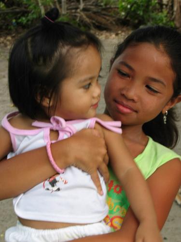 baby sitting - i took this photo when i had my vacation to my country. i spend time with my family and friends, the photo you see is my youngest niece, she is like my carbon when i was a baby so it is really fun to look at. anyway, i love this shot of mine coz it shows love and childhood at the same time.