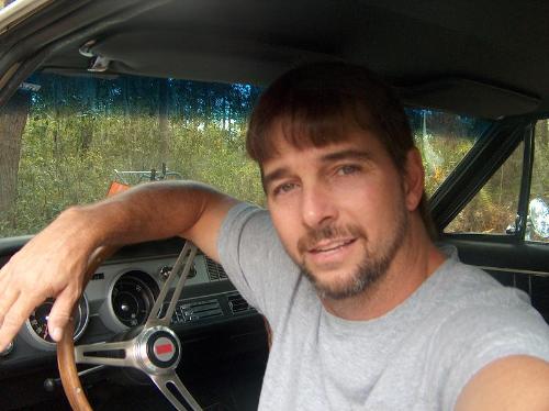 me in a 67 olds cutlass - me sitting in my completely original 67 olds cutlass relaxing and enjoying a beautiful day.