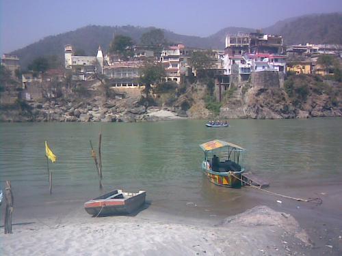 Boating and rafting at Ganga - People do voting and rafting in Ganga at Rishikesh