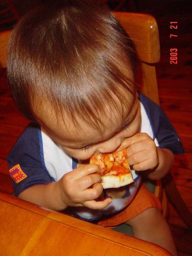 Little kid eating pizza. - eating pizza