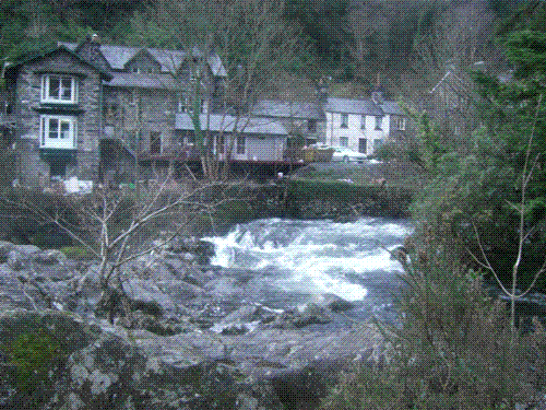 Afon Lugwy near Pont-y-pair, Betws-y-coed - Spring floods bring the normally placid stream to full flood as it thunders through the village