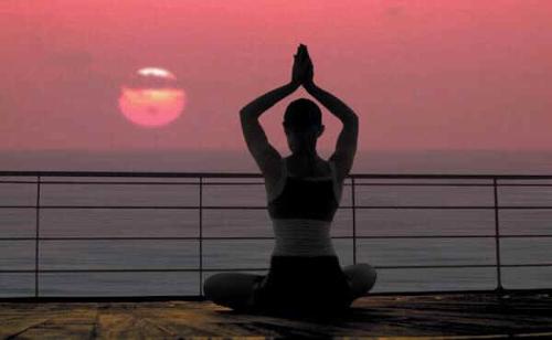 Yoga - A woman practicing yoga at sunrise. Yoga - A woman practicing yoga at sunrise.