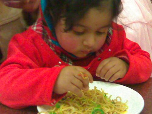 Sia eating noodles - Last month we went to Puri. There we ordered noodles in a restaurant. Sia is eating her noodles.