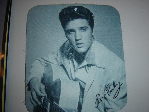 Elvis Presley - Mousepad that is on a wall in the computer room.