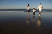 family bonding together - a photo of a family walking on a beach