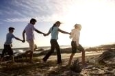 family having fun - a photo of a happy family on a beach