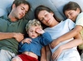 family sleeping together - a photo of a family sleeping together