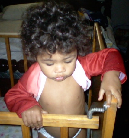 My daughter trying to undress - She just can't quite do it yet.