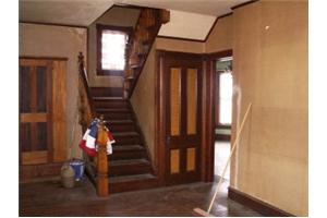 the entryway/foyer - I love this photo. It shows off the original woodwork. Obviously those are the stairs lol and notice the stained glass in the window on the landing, so pretty. Through the door way is the dining room to the left (visible) and the two living rooms to the right (not pictured)