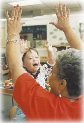 special child - A special child happily learning from his teacher