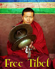 free Tibet - A Tibetan/ holds a sign for Free Tibet.