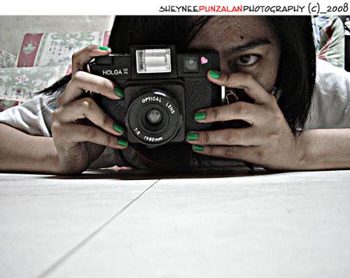 Thy lomgrapher - A photography of yours truly with my favorite toy camera. Holga120 fn,it uses 120 films. It has a built in flash but they say that the flash is weak. I enjoy using this camera because it does not only use 120films but it can also use a 135films.