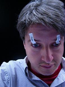 sleeping - Man sleepy, wide awake with tape on eyes.