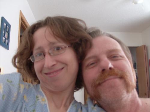 William and I - My husband and I at home smiling at the camera for a kodack moment.