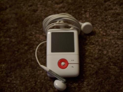 MP3 Play - A White and Red Creative Zen MP3. Has a pair of white headphones.