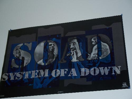 SOAD Poster - A Poster of System Of A Down or SOAD. On black and blue poster paper. Each band member is in a letter. Bassist Shavo Odadjian in the letter S. Guitarist Daron Malakian in the letter O.  Vocalist Serj Tankian in the letter A.  Drummer John Dolmayan in the letter D.
