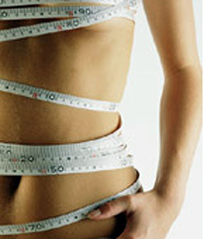 Measurements - This is a picture of a wmaons body wrappedin a measureing tape, it is intended to depict societies obsession with size and weight.