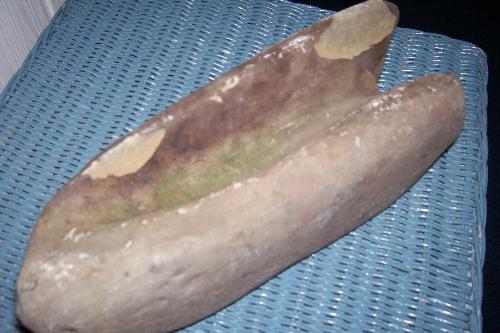 My Mysterious Rock of Unknown Origin - This rock is approximatley 11' long and is hollowed out on the top side and the bottom. One end is solid. The opposite end is hollowed out connecting the top and bottom.
