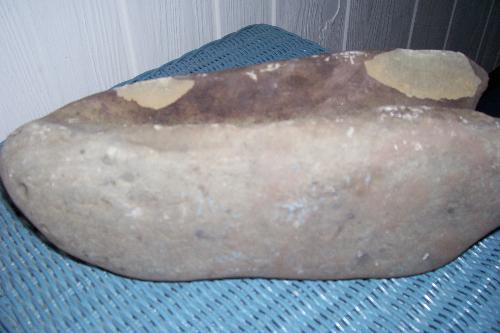 Anyone scientists recognize this type of rock? - Okay, here's another shot of my strange rock. You can see how both top and bottom are hollowed out.   Please help if you are smart. Or if you are dumb but are intelligent enough to understand rocks.
