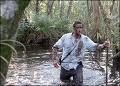 Science channel clip - Man walking through marsh with nothing else