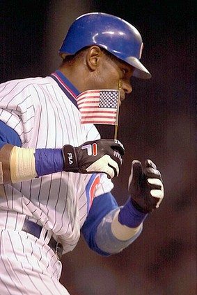 Sammy Sosa - Sammy Sosa carries an American flag with him in the first Cubs game at Wrigley Field following 9/11