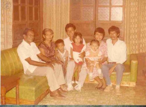 Family Picture: Me wearing red sitting at the lap  - Family Picture: Me wearing red sitting at the lap of my uncle. I was only five.