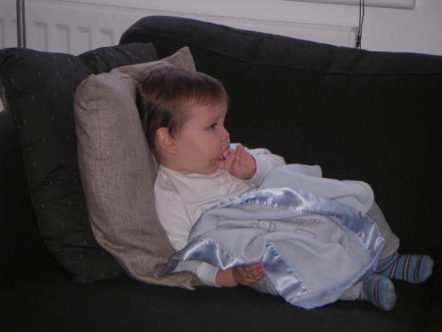 child - my baby being ill, sitting on tha sofa