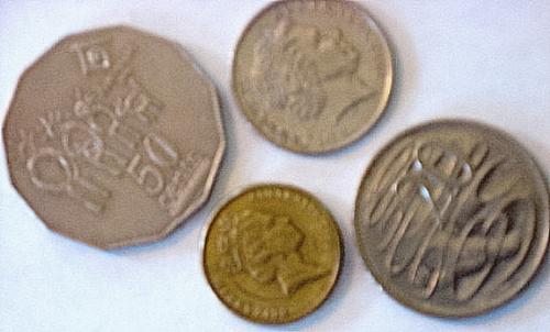 Australian Coins - The small copper colored one is a $2 coin. The others are 50 cents, then one says 10 and another says 20. But it doesn't specify if it's cents or dollars.